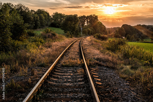 railway tracks, trees and sunset