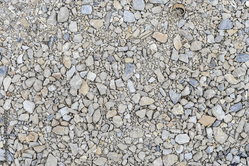 Texture of stones with sharp edges piled on the sidewalk