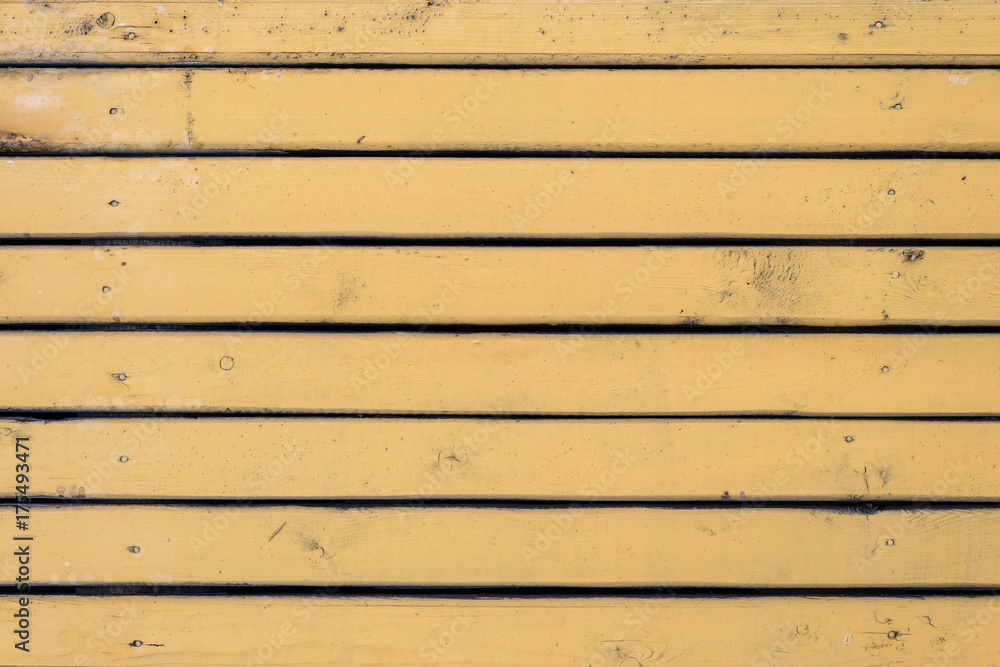 Naklejka premium Texture of thin wooden boards painted with yellow paint