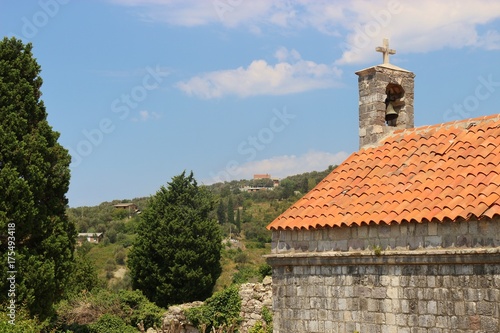 Small church and trees in Stari Bar or old Bar in Montenegro, a very old ruined city and fortress founded in 8 BC. Southeast Europe.
