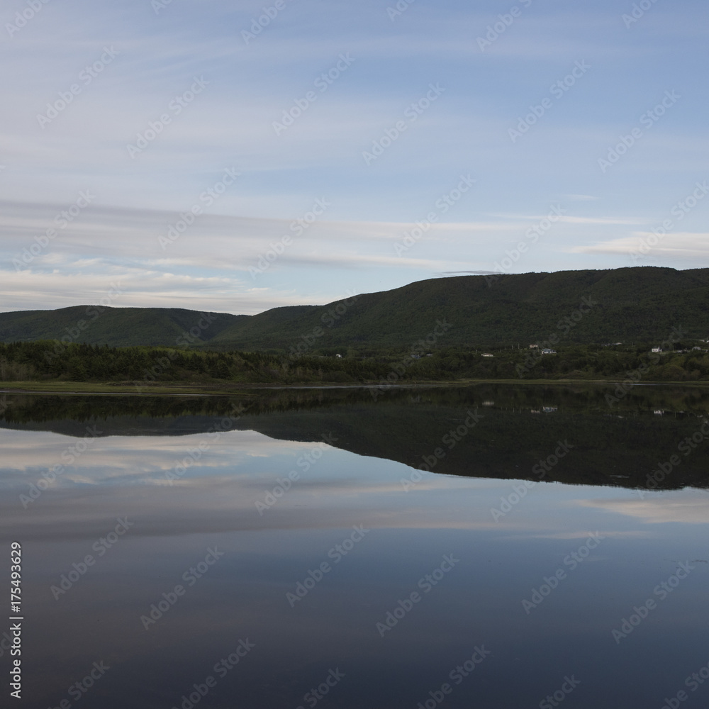 Scenic view of calm river with mountains in background, Cheticamp, Cabot Trail, Cape Breton Island, Nova Scotia, Canada Scenic view of calm river with mountains in background, Cheticamp, Cabot Trail, Cape Breton Island, Nova Scotia, Canada