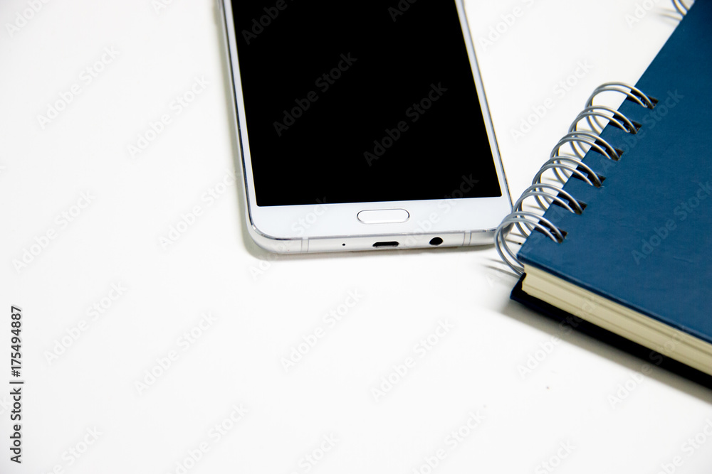 Office table with notepad and smartphone. View from above with copy space for text Office table with notepad and smartphone. View from above with copy space for text