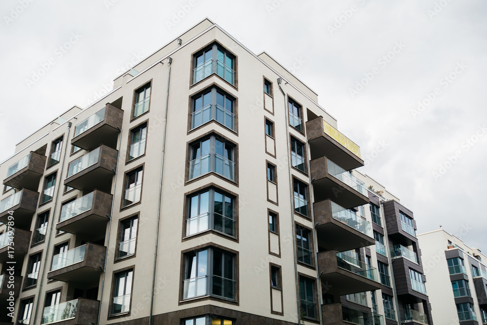 modern apartment building with glass balcony on a cloudy day modern apartment building with glass balcony on a cloudy day