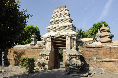 JOGJAKARTA, INDONESIA -JUNE 12, 2014: Entrance arch at old Masjid Besar Mataram Kotagede, Jogjakarta Indonesia. The arch was made from brick and hand made carving stone in traditional Balinese Style photo