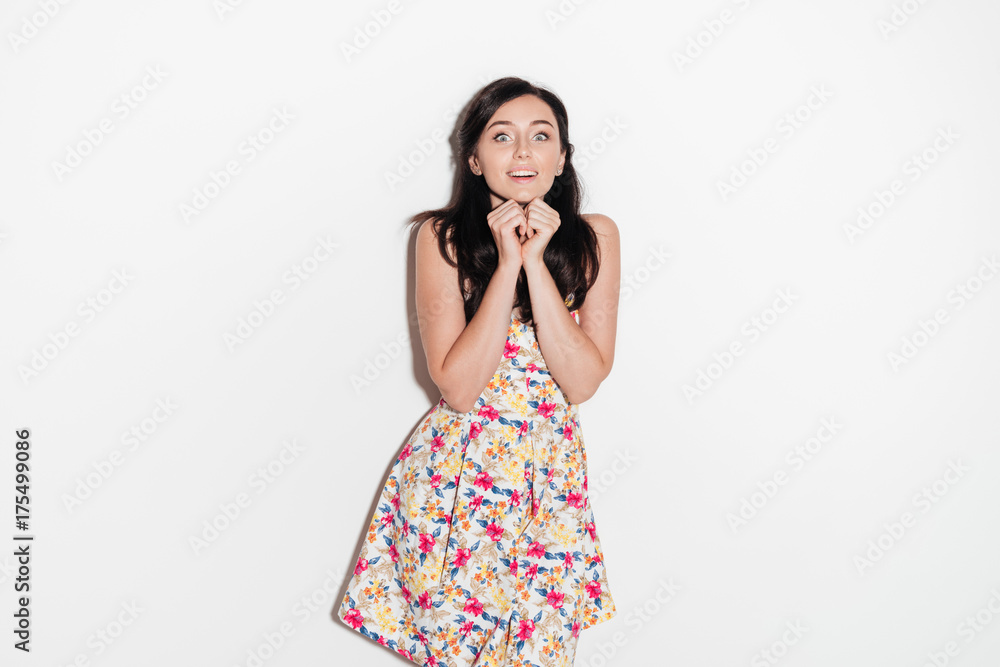 Surprised happy brunette woman in dress looking at the camera Surprised happy brunette woman in dress looking at the camera