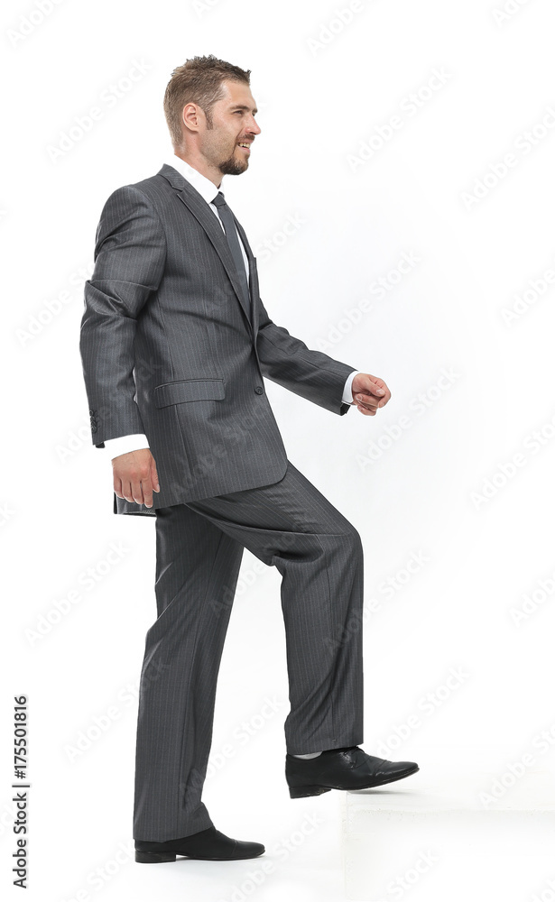 in full growth.side view.businessman stepping forward in full growth.side view.businessman stepping forward