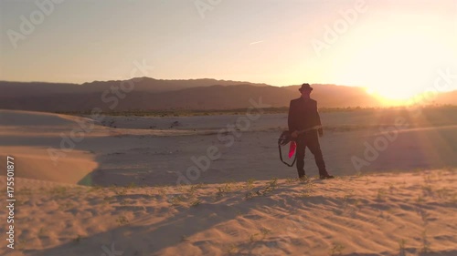 Rock star walking On the sand dunes of Mojave Desert music life in Palm Springs California area summer fall sunset
