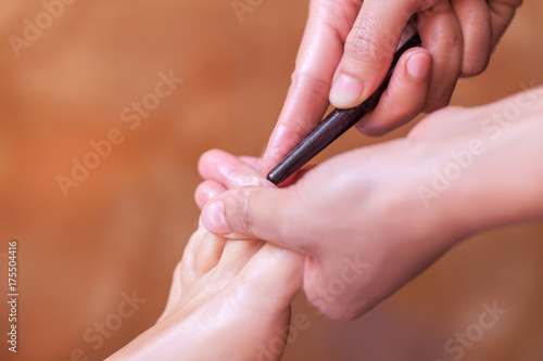 reflexology foot massage  spa foot treatment by wood stick Thailand