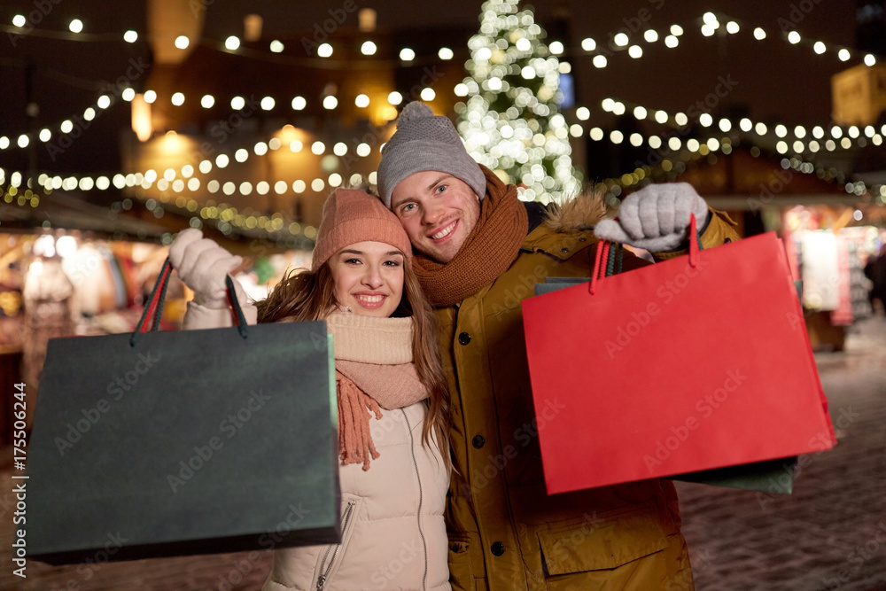 happy couple at with shopping bags in winter happy couple at with shopping bags in winter