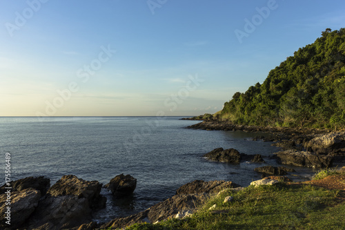 Beautiful aerial view point of tropical sea bay and island, with mountain cliff and rocks in foreground © uaychai