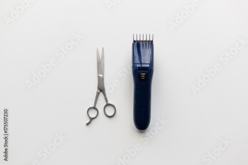 hair trimmer and scissors on white background