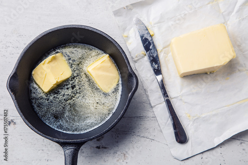 Konstfotografi Butter. Pieces of butter in the hot pan top view