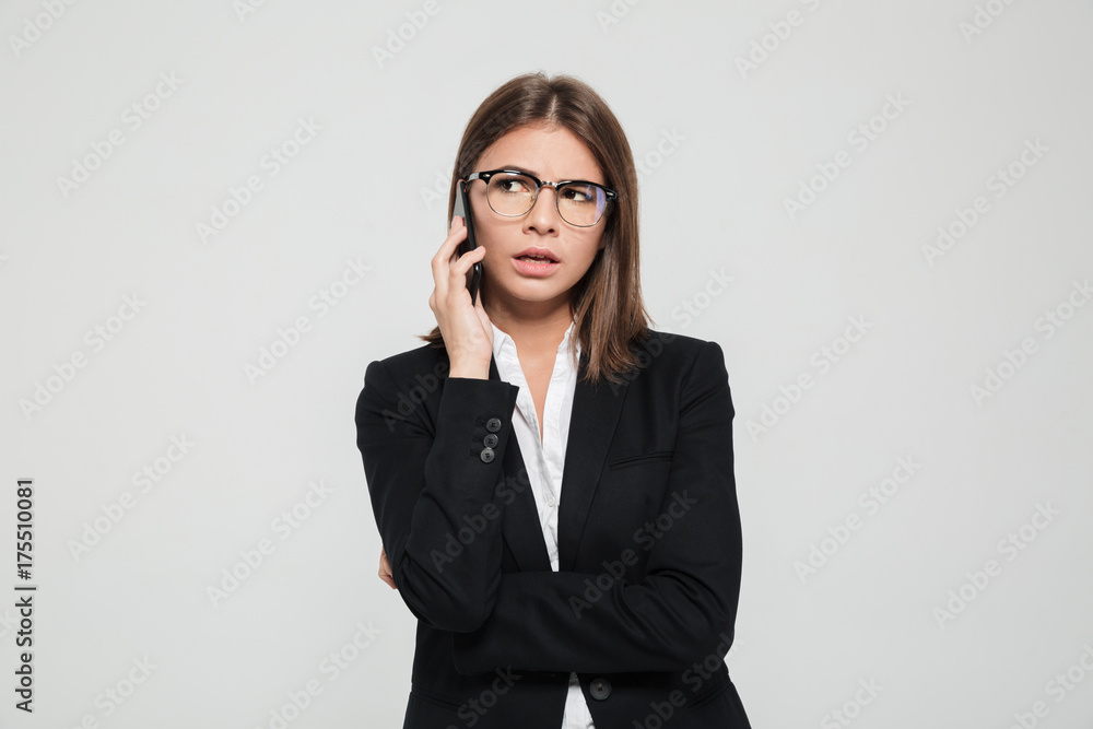 Portrait of a confused young businesswoman in eyeglasses Portrait of a confused young businesswoman in eyeglasses