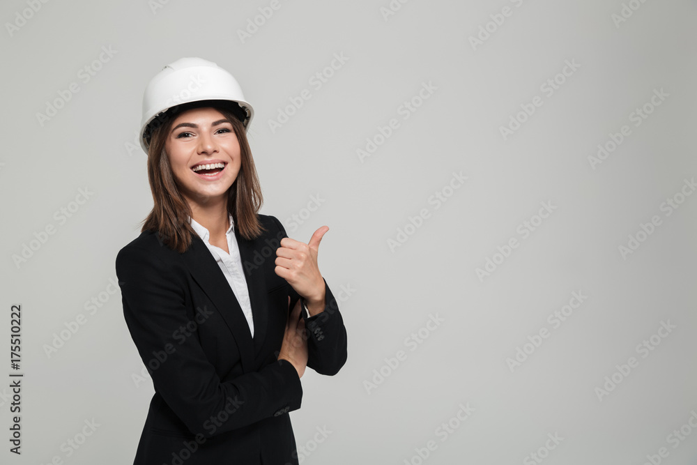 Portrait of a cheerful pretty woman in hard hat and suit Portrait of a cheerful pretty woman in hard hat and suit