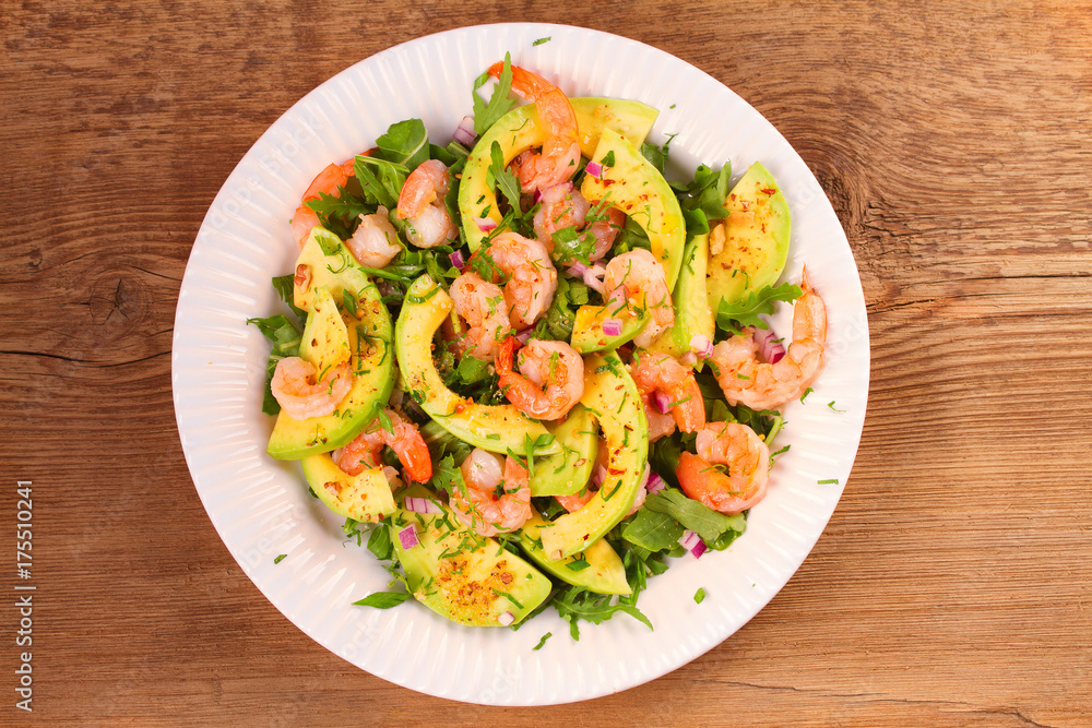 Shrimp salad with avocado arugula, scallion and almonds. View from above, top studio shot, horizontal Shrimp salad with avocado arugula, scallion and almonds. View from above, top studio shot, horizontal