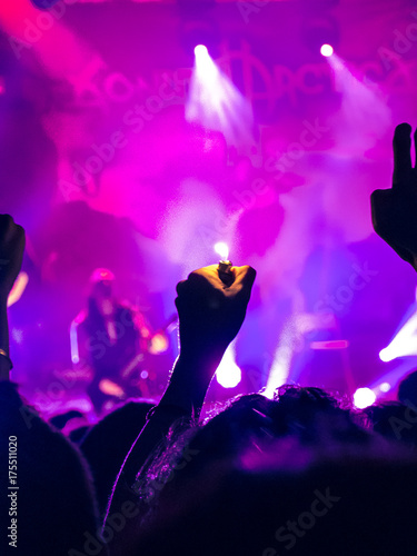 Concert crowd clapping and raising hands photo