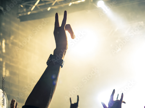 Concert crowd clapping and raising hands photo