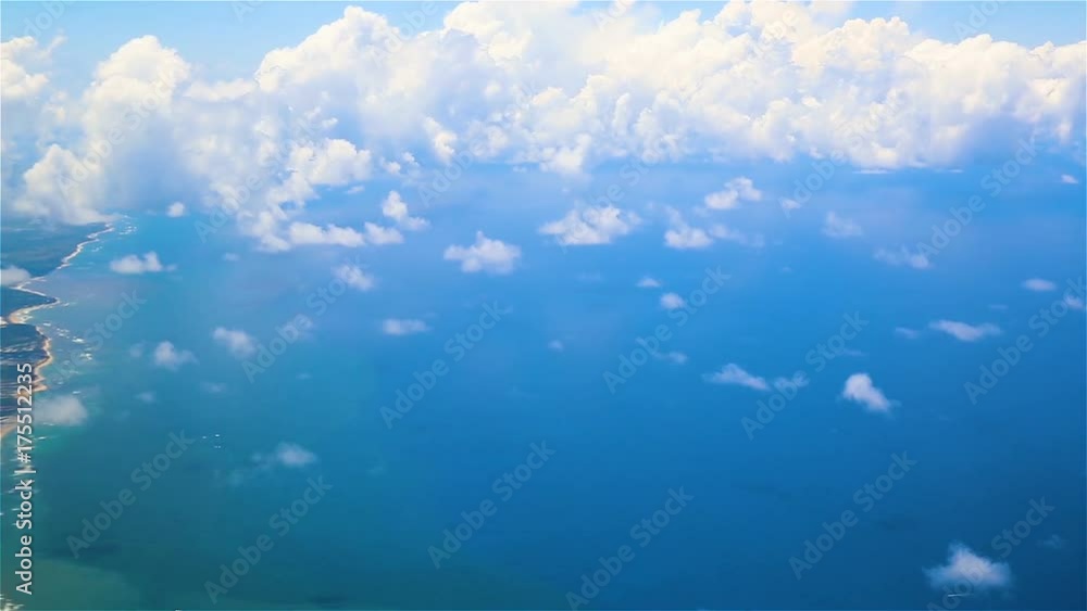 Traveling by air above clouds. View through an airplane window. Flying over the Atlantic Ocean. Traveling by air above clouds. View through an airplane window. Flying over the Atlantic Ocean.