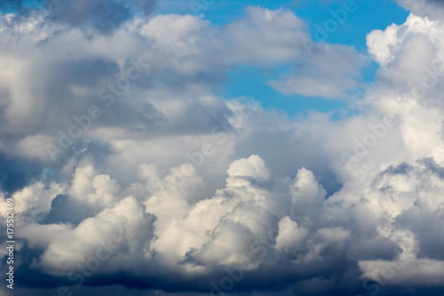 Classic painterly cloudscape. Fluffy white clouds against blue sky background.