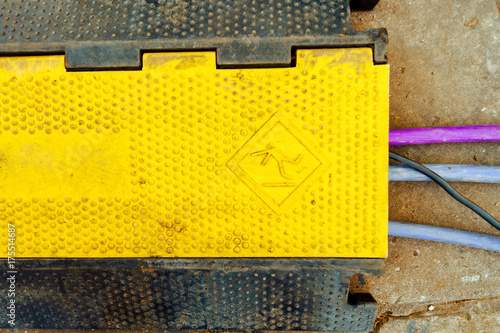 Close-up of a plastic cable protector on a street photo