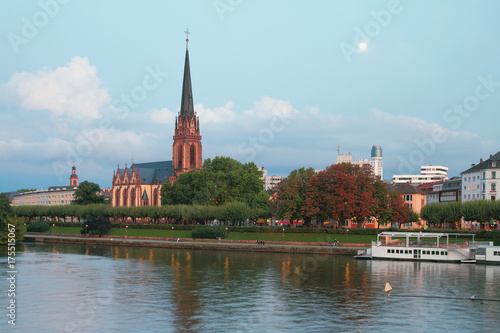 Evening river, embankment and church. Frankfurt am Main, Germany