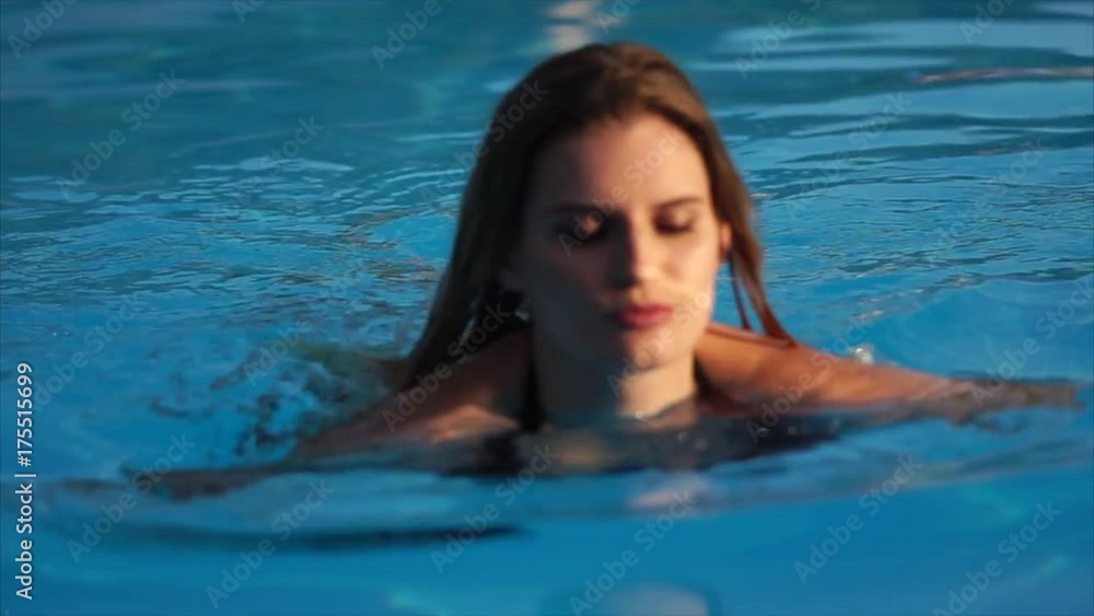 Portrait of a young sensual woman with wet skin and hair near the swimming pool Portrait of a young sensual woman with wet skin and hair near the swimming pool