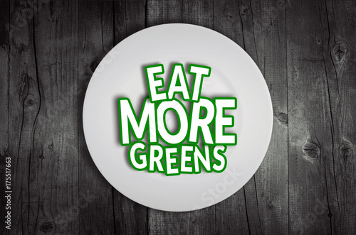 Eat more greens plate on wooden table background