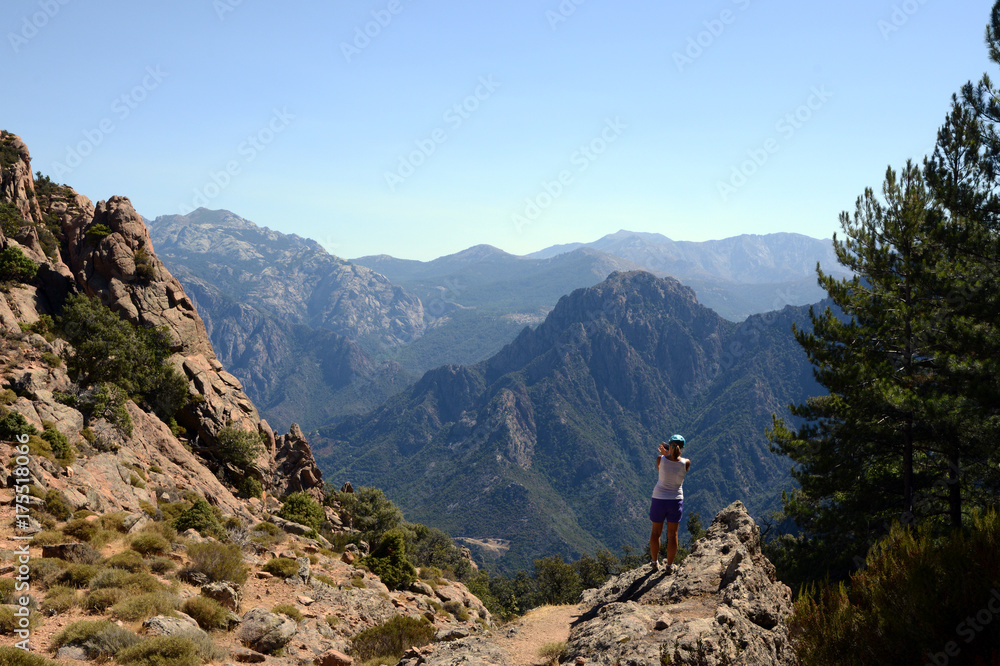 Tourist resting and watching the mountains, Corsica