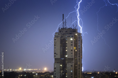 Thunderstorm over night city photo