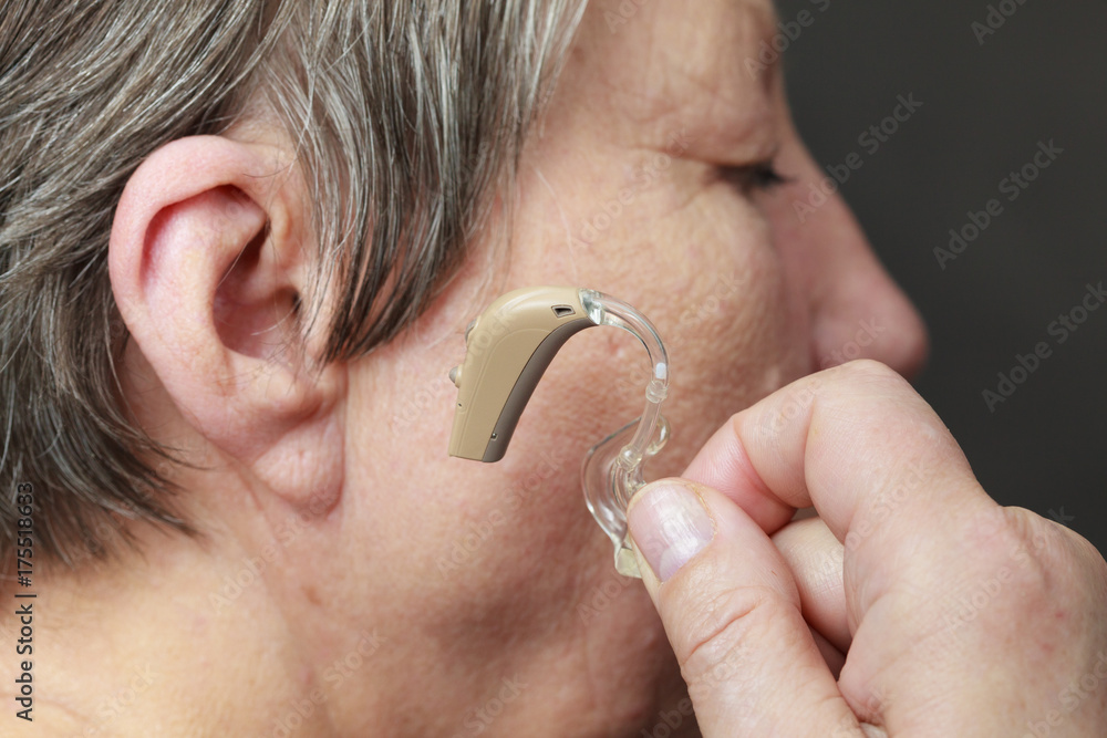 Fototapeta premium Closeup senior woman using hearing aid