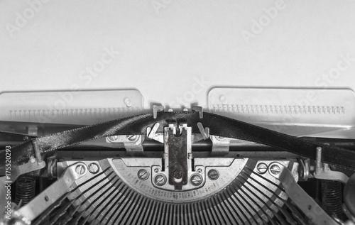 mock up a blank sheet of paper in a vintage typewriter. Mechanisms close-up. Input on an old typewriter. Blank page for mockups or simulations.