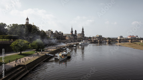 river in city against cloudy sky 