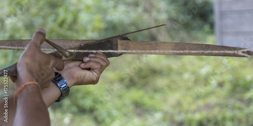 Person hand aiming with crossbow, Luang Prabang, Laos