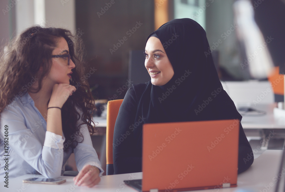 Two Muslim business woman working on their laptop. Two Muslim business woman working on their laptop.