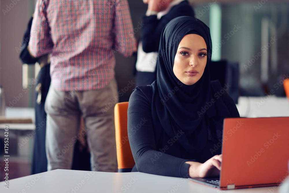 Multiracial contemporary business people working connected with technological devices like tablet and laptop Multiracial contemporary business people working connected with technological devices like tablet and laptop