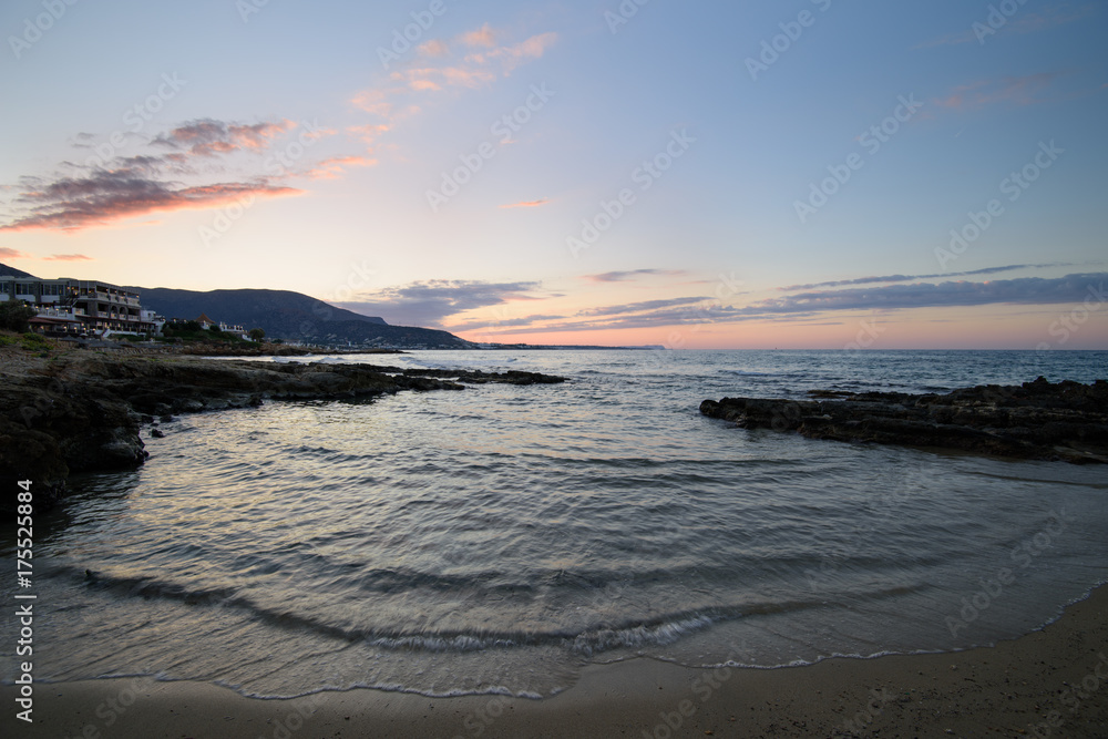 Obraz premium Sunset over the sea. Stalida, Crete, Greece. Autumn, the end of the tourist season.