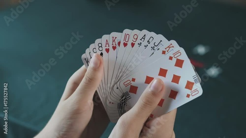 Bridge card game,female hand  shuffling cards close up photo