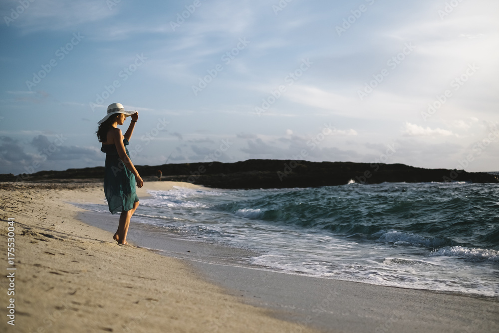 Young woman relaxing and walking on the beach Young woman relaxing and walking on the beach