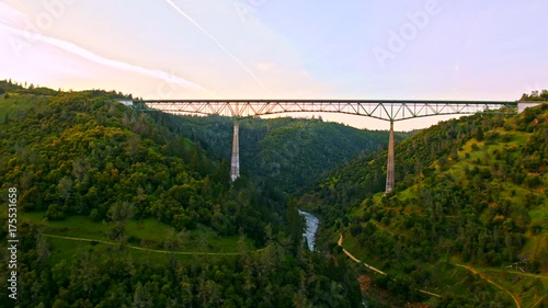 Cinematic aerial of The Foresthill, Auburn-Foresthill or Auburn road bridge crossing over the North Fork American River in Placer County and the Sierra Nevada foothills, in eastern California.  photo