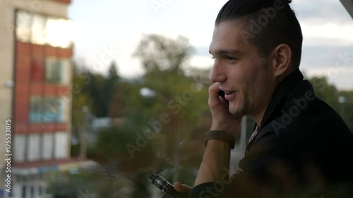 Attractive and handsome businessman using mobile phone, asian businessman having a phone talk, wealthy man talking on the smart phone seated in cafe at his work break photo