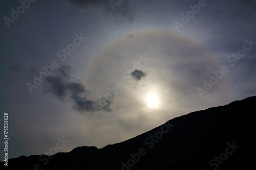Solar phenomenon of the halo in the sky over the mountains.