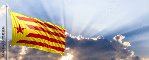 Catalonia waving flag on blue sky. 3d illustration photo
