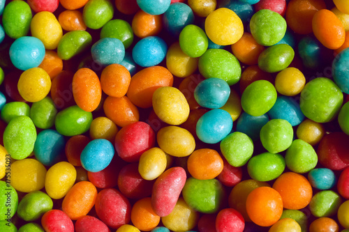 Tasty candy decoration background. Heap of colors candies for kids with small green, yellow, blue sweets