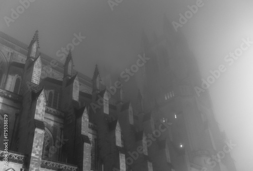 Gothic cathedral in mist on spooky night photo