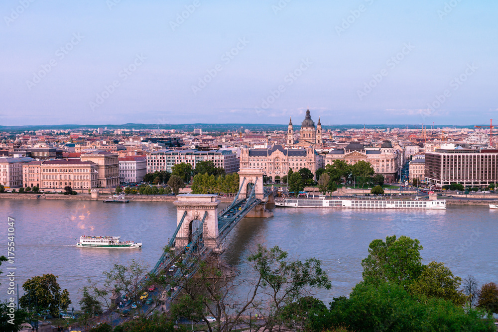 Budapest, night view of Chain Bridge on the Danube river and the city of Pest at the evening