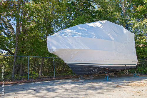 power boat covered with white shrink wrap