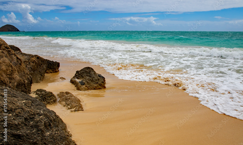 Seascape of rocks and approaching waves at Bellows Beach, Oahu, Hawaii 