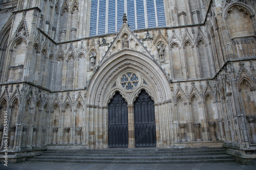 stone carved entrance to a cathedral with statues and arches stone carved entrance to a cathedral with statues and arches