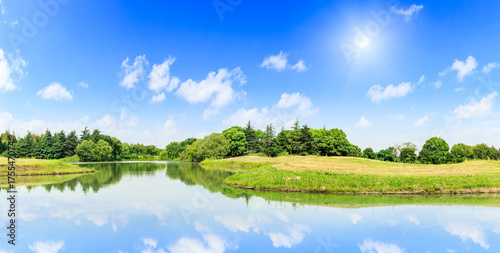 green forest and lake water under the blue sky © ABCDstock