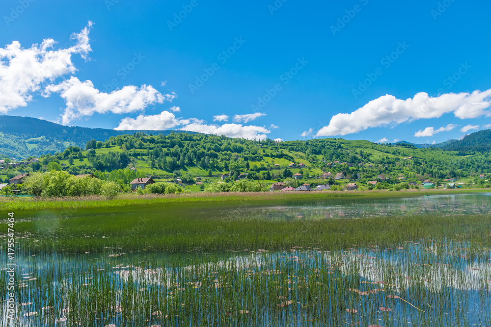 A large mountain lake in a picturesque valley. A large mountain lake in a picturesque valley.